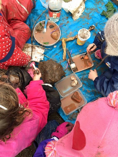 Children making use of natural materials for art.